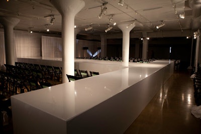 The fashion show took place upstairs on a white, T-shaped runway.