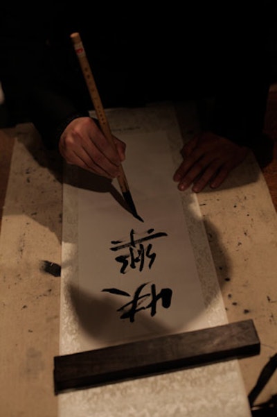 A pair of French colonial villas were turned into a Chinese festival for the evening, with contortionists, juggling, paper cutting, and opera painting. An on-site artisan drew Chinese characters onto scrolls marked with the Dunhill logo for guests.