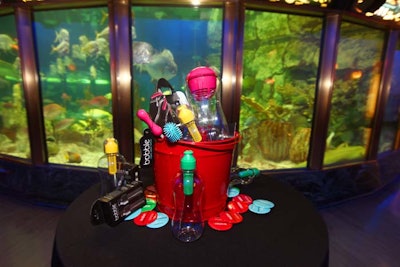 Beach pails held Bobbles, glass cleaners, and the company's new filter jugs. On the tabletops, colorful buttons bore the slogan 'Bobbled, Not Bottled.'