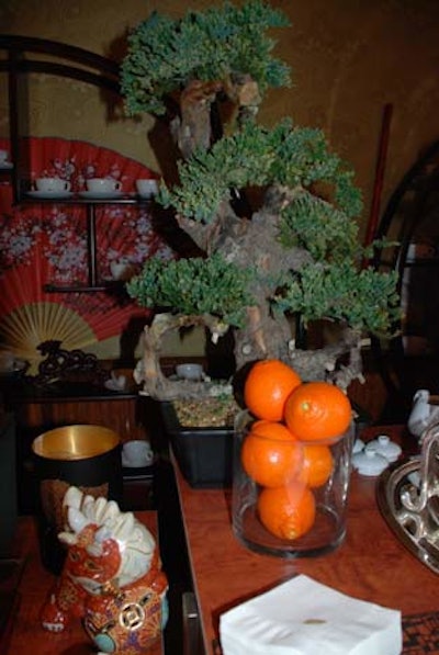 Oranges, folding fans, and bonsai trees underscored the afternoon's theme.