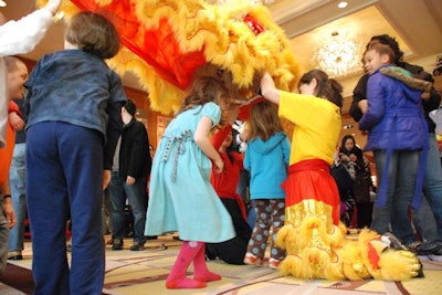 Dancers let kids explore the inside of the lion costume.