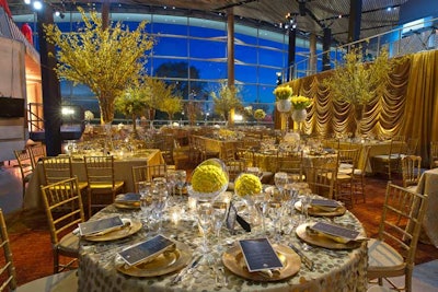 Gilded topiary arrangements added height to the table designs.