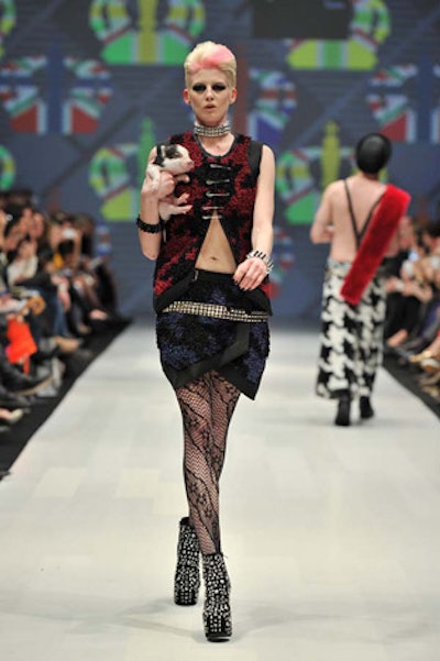 Korhani showed three collections that used three sources of inspiration: Mongolia, punk, and Venice. Models walking in punk looks carried tiny piglets, to the delight of the audience.
