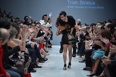 Guests cheered during the high-energy Dare to Wear Love show when W.W.E. wrestler and fitness model Trish Stratus picked up an unsuspecting guest from the front-row and carried him down the runway.