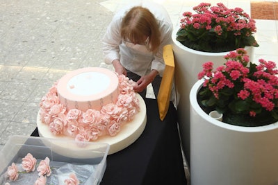 An assistant decorated a tier of a cake from Terracocoa. Chef and owner Marilyn Mueller chose the Galleria's 'Pretty Pale' spring trend of nudes and pinks as inspiration for her wedding cake design.