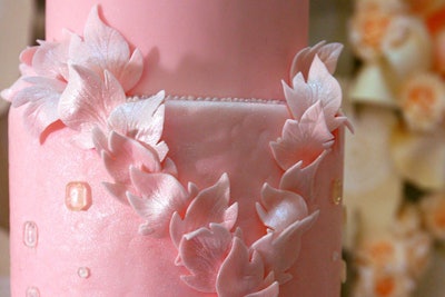 Delicate floral patterns enhanced Mueller's soft pink, tiered cake.