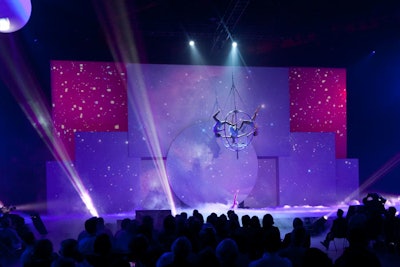 Fog filled the bottom of the stage as three acrobats performed inside an open steel sphere during the science segment.