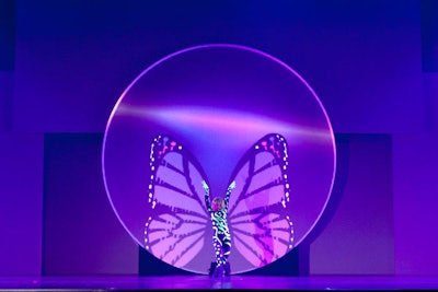 A dancer appeared to be attached to butterfly wings that moved on the screen behind her. Corporate Magic's Stephen Dahlem said they created the effect by first recording a dancer in front of a green screen in order to determine placement of the wings.