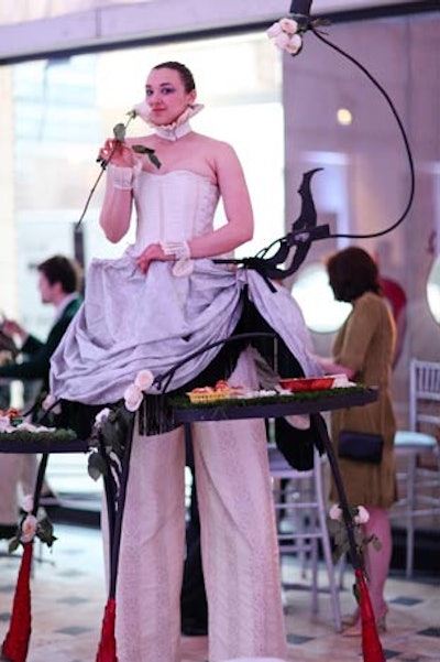 Another Stilted Server, this one in an all-white ensemble, offered snacks in the V.I.P. lounge.