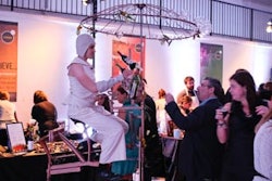 The company's mobile 'Wine Bike' has a spinning chandelier of wine glasses, and uses a series of gears to pour bottles of wine.