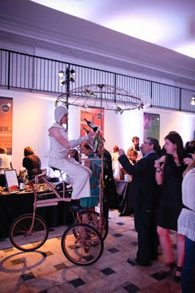 The company's mobile 'Wine Bike' has a spinning chandelier of wine glasses, and uses a series of gears to pour bottles of wine.