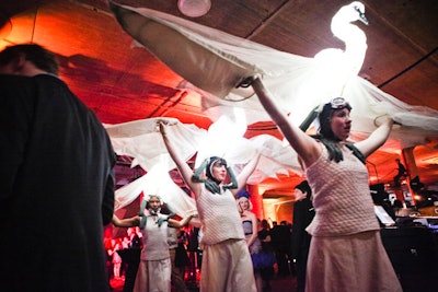 A trio of roving characters in illuminated swan headdresses made their way throughout the space.