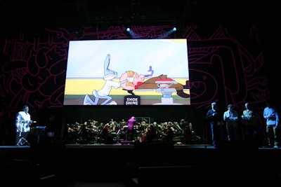 For the finale, the lower panel of the screen's backdrop lifted to reveal the Orchestra of St. Luke's, which performed instrumental versions of the themes for series like the Looney Tunes Show, Powerpuff Girls, Star Wars: The Clone Wars, and Dexter's Laboratory. The show was also streamed lived to a private webcast for network staffers.