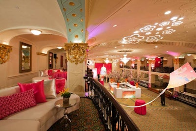 White lounge furniture with pink and silver pillows provided seating on the grand ballroom's second-floor balcony, which went unused last year.