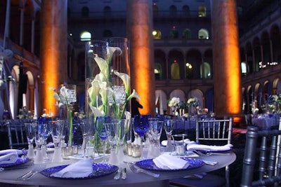 Another centerpiece consisted of white calla lilies in tall, cylindrical vases surrounded by votives at the base.