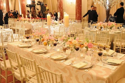 The garden-party decor included pastel tablecloths, floral plates, and glass candle holders, and spring floral arrangements with sweet pea, hyacinth, and roses.