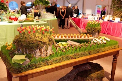Windows Catering Company provided a nature-themed hors d'oeuvres table with items placed on things from nature including tree trunks.