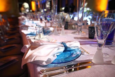 The place settings on each table, either blue or clear, contrasted the linens.