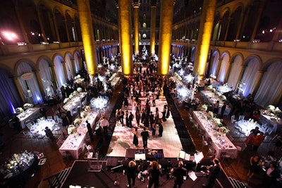 Tables lined the sides of the main dance floor and stage at the far end of the grand hall and spread back to meet the reception area.