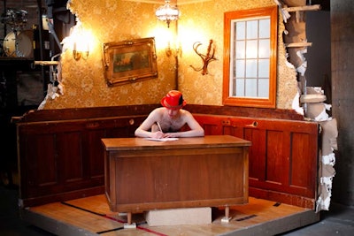 Just beyond the entrance, a performer mimed working in an installation that resembled the interior of the decaying office. The setting was later elevated and used during the evening's central performance, which offered a preview of Redmoon's upcoming work.