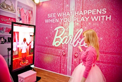 Barbie reps demonstrate how to navigate Barbie's virtual dream closet. By moving their hands over arrows, guests can 'try on' different Barbie outfits and snap a photo of themselves.