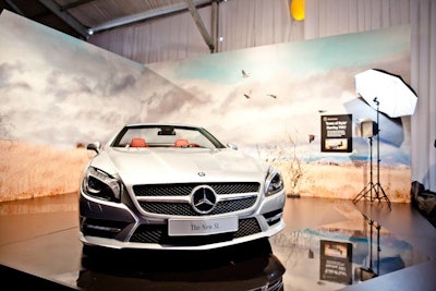 Mercedes-Benz shows off the new SL Roadster inside the tent. Guests can pose for photos in front of a backdrop that replicates a Mercedes fashion collaboration with supermodel Lara Stone.