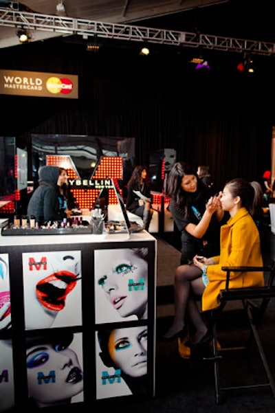 Maybelline reps give guests complimentary makeup touch-ups at their area in the tent. Afterward, guests can pose for a photo in front of a Maybelline step-and-repeat.