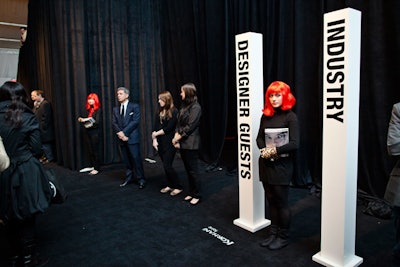 The tents have two clearly marked lines to enter the show, one for designer guests and one for industry attendees. Fashion Week volunteers are identified by their bright red wigs.