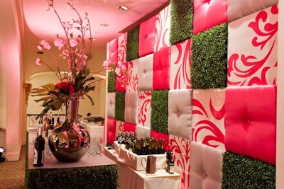 Chicka Chicka Boom Boom created a wall of grass, pink, and white tufted squares to serve as the backdrop of the balcony bar.