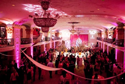 Pink lighting filled the grand ballroom of the hotel.