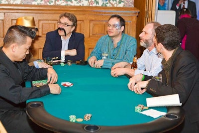 Guests played poker at small tables set up around the ballroom.