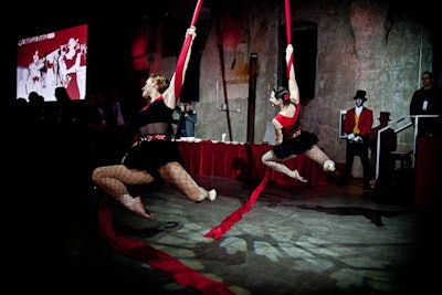 Dressed in corsets, fishnets, and feather boas, performers matched the Nouveau Rouge theme.