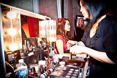 Make Up For Ever reps gave guests makeup touch-ups and hairstyles to match the Nouveau Rouge theme.