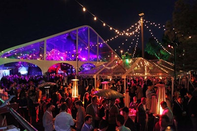 A clear-span tent and illuminated trees made the indoor-outdoor space feel expansive and inclusive.