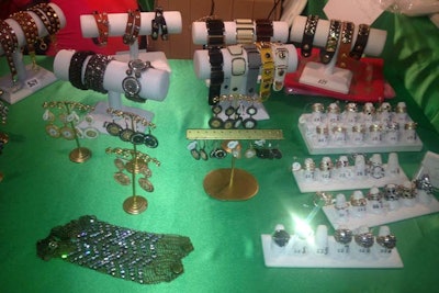 Jewelry Bar N.Y. set up bracelets, earrings, and rings on a table swathed in silky green linens.