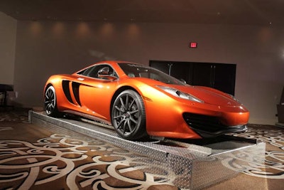 Luxury cars that were auctioned off during the night doubled as decor.