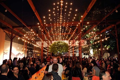 String lighting above the outdoor party space lit up in patterns that corresponded to music.