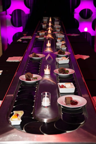 Two conveyer belts at sponsor G.E.'s dessert station rotated plates of treats including a semifreddo of chocolate ganache, fruit sushi bento, and chocolate cherry terrine.