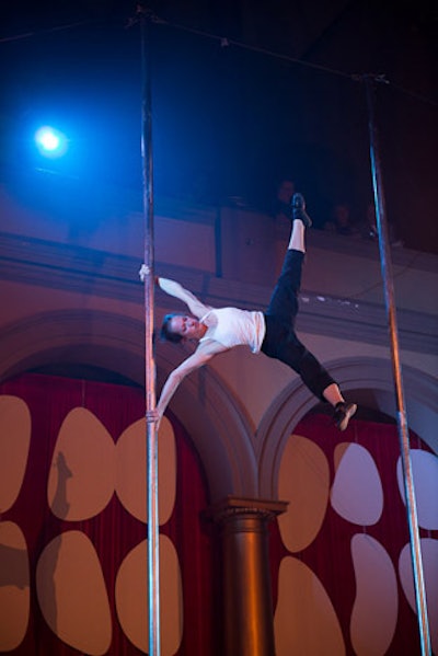 Using two tall poles on the stage, acrobats from show Traces climbed and jumped from pole to pole, then slid down and caught themselves right before they hit the stage.