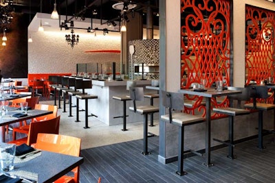Orange is the main hue at La Forchetta, as seen in the banquettes and polished chairs from Italy, set off by charcoal dining tables.