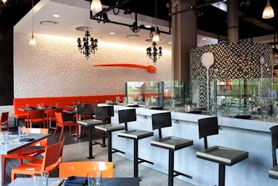 Guest sitting at the concrete bar can watch as Neopolitan pizzas bake at up to 900 degrees in the mosaic-tiled, 800-pound woodburning pizza oven.