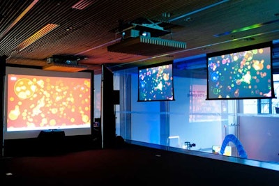 An interactive Twitter installation took up a seminar room of the Weston Family Learning Centre. Tweets were projected onto screens and the largest screen was interactive. As guests approached the screen, bubbles moved to form silhouettes.