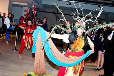 Artist Cesar Forero choreographed a performance with elaborately costumed dancers and singers. The piece was designed to explore the relationship between people and land.