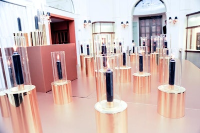 To create an inviting atmosphere at the preview, a table glowing with hurricane candles set atop brass fixtures stood inside Cartier's Fifth Avenue flagship. The installation was placed directly adjacent to the elevator that took guests to the exhibition on the second floor.