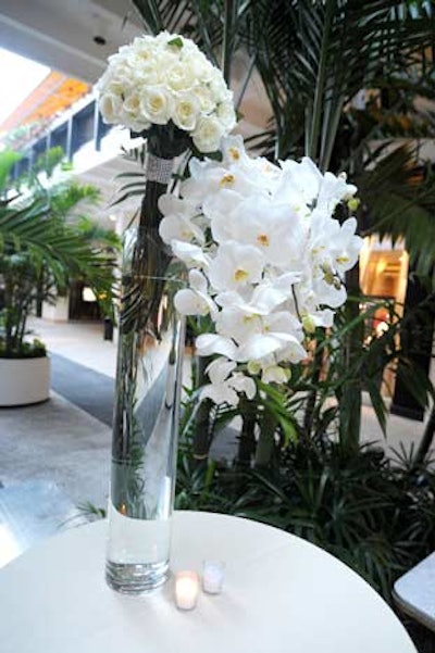 Replica Chopard pieces adorned flower arrangements of white orchids, hydrangeas, and roses.