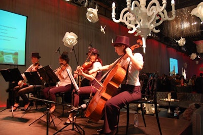 A quartet played from a central stage during the cocktail reception. The women wore fake mustaches, top hats, and suspenders to add to the decor.