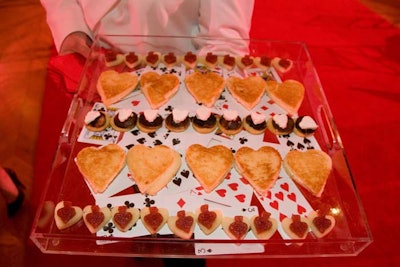 During the reception, caterwaiters served tea sandwiches shaped like hearts, spades, and diamonds on trays inlayed with playing cards.