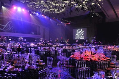 Lucite Chivari chairs and dramatic lighting from I.E.P. enhanced the dining room's black-and-white color scheme.