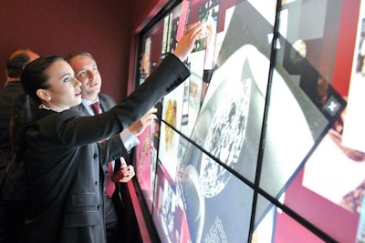 To infuse more modern, high-tech elements into the exhibit, a large Hewlett-Packard touch-screen was erected across one wall. Showcasing hundreds of images, the installation was designed to complement the exhibition and flaunt as much of Cartier's extensive content in an engaging way. Guests like actress Lily Collins (pictured) were able to access information on each image as well as articles on specific objects.