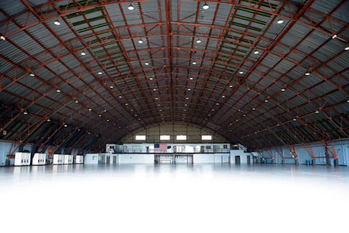 Santa Monica’s Barker Hangar has an indoor capacity of 3,000, or 1,600 for a seated event. It has a dramatic ceiling that vaults to 43 feet at the center, providing an arched steel truss over a 150- by 234-foot cement floor. The 35,000-square-foot hangar has an additional 6,000 square feet of dressing, production, and conference rooms.